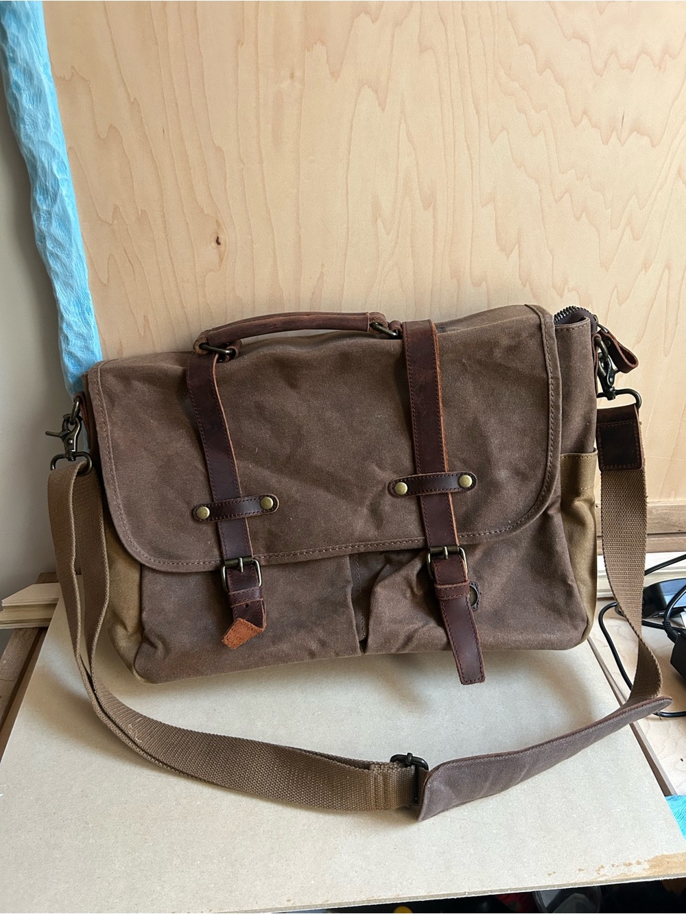 Newhey brown waxed canvas and leather messenger bag designed for laptops.